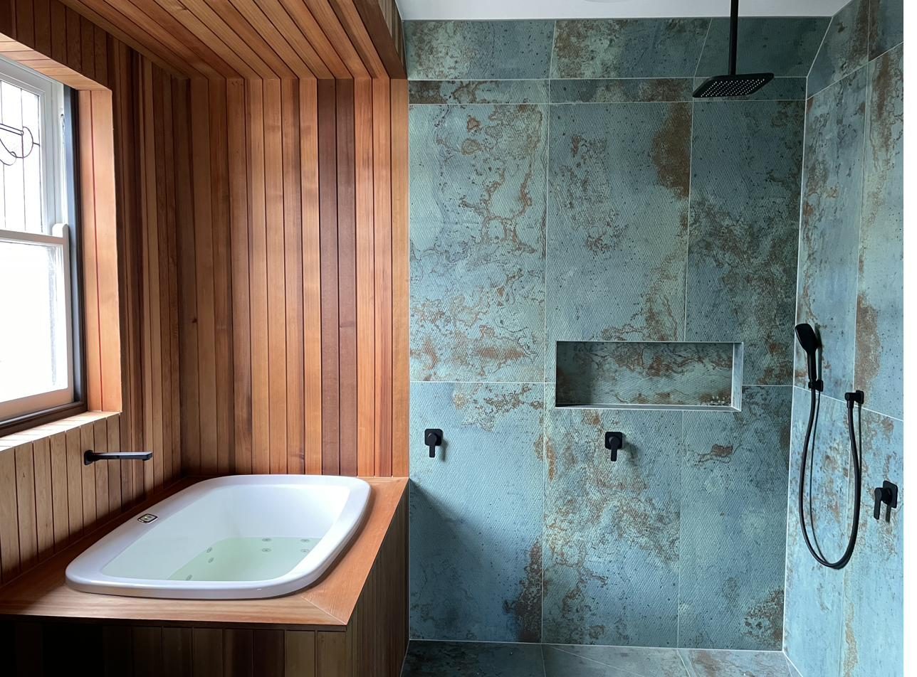 AQVA insert bath in an ensuite with a shower alongside
